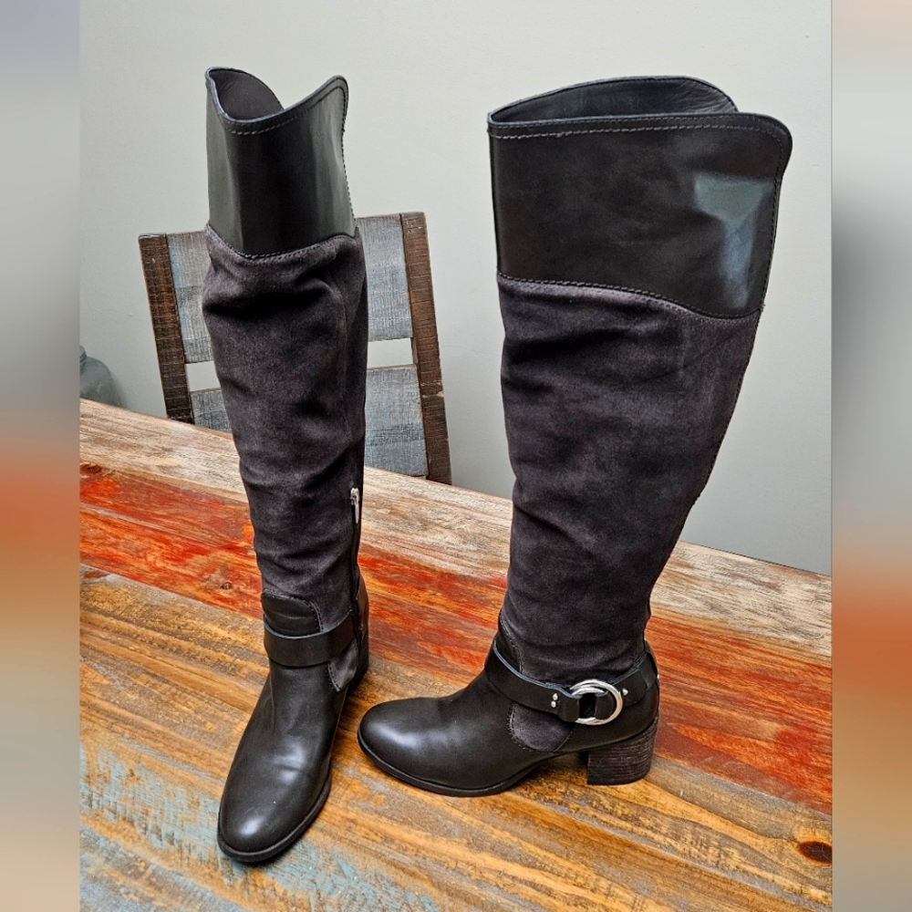 Brown suede and leather knee-high boots with buckle detail.